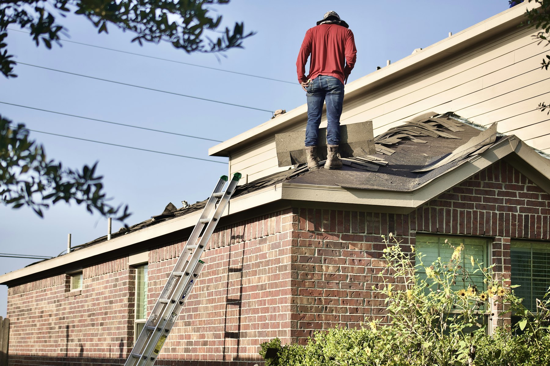 Roofing professional working on a home